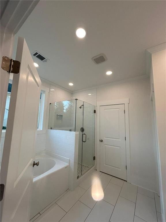 bathroom featuring shower with separate bathtub and tile patterned flooring