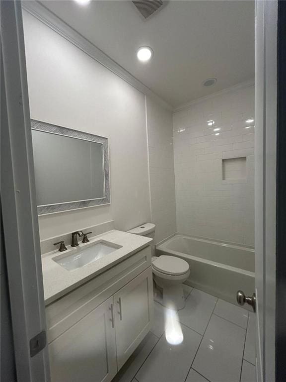full bathroom featuring toilet, tiled shower / bath, vanity, and tile patterned floors