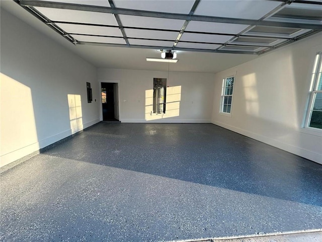 garage featuring a garage door opener and electric panel