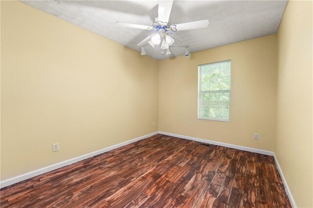 1382 Hollenbeck Ln, Riverdale, GA 30296 - empty room featuring dark wood-style flooring, a ceiling fan, and a textured ceiling
