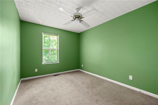 1382 Hollenbeck Ln, Riverdale, GA 30296 - empty room featuring ceiling fan, carpet, and a textured ceiling