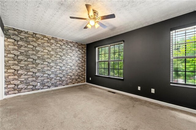 1382 Hollenbeck Ln, Riverdale, GA 30296 - unfurnished room featuring carpet, a ceiling fan, healthy amount of natural light, and a textured ceiling