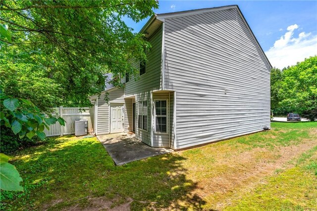 1382 Hollenbeck Ln, Riverdale, GA 30296 - view of side of property with a central air condition unit and a patio area
