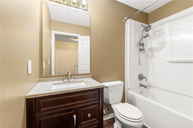 1382 Hollenbeck Ln, Riverdale, GA 30296 - bathroom with a textured ceiling, vanity, and bathing tub / shower combination