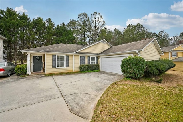 ranch-style home featuring a front lawn, concrete driveway, and a garage