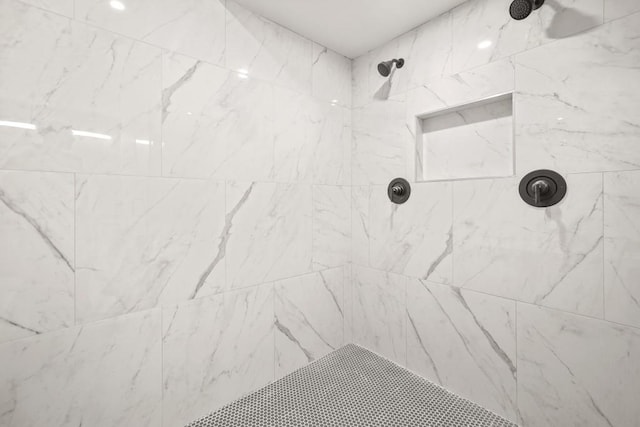 bathroom featuring tiled shower