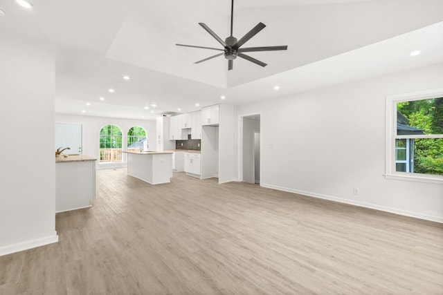 unfurnished living room featuring recessed lighting, a ceiling fan, baseboards, and light wood finished floors