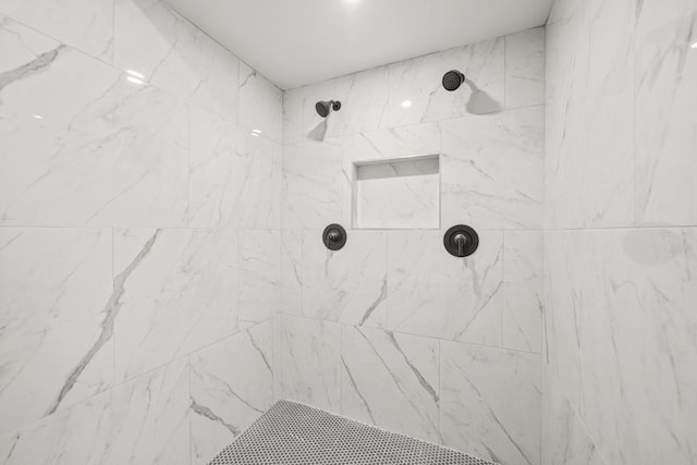 bathroom with tiled shower