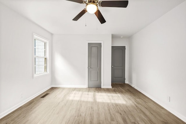 unfurnished bedroom featuring light wood-style floors, baseboards, and visible vents
