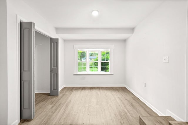 unfurnished bedroom with light wood-style floors and baseboards