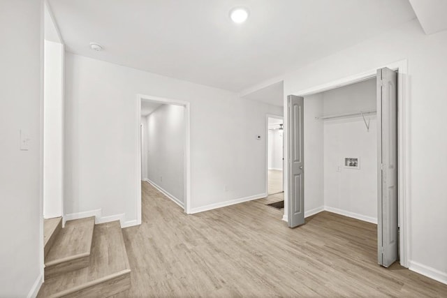 unfurnished bedroom with baseboards, a closet, and light wood-type flooring