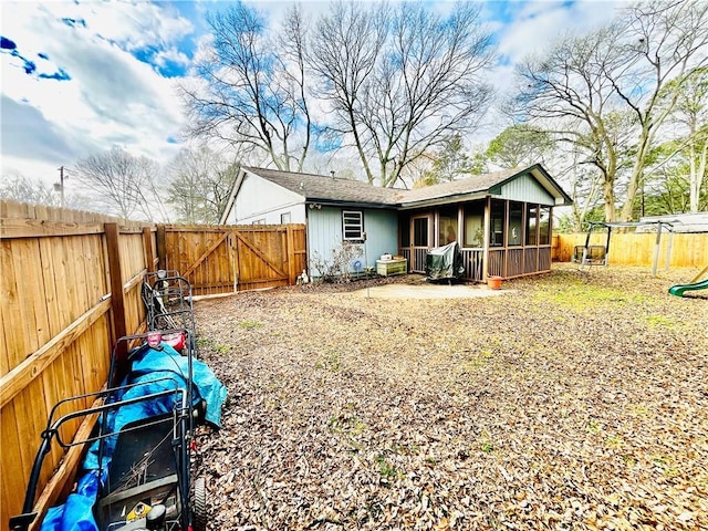 rear view of property featuring a sunroom