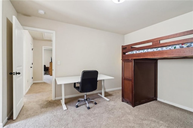 interior space featuring baseboards and light carpet