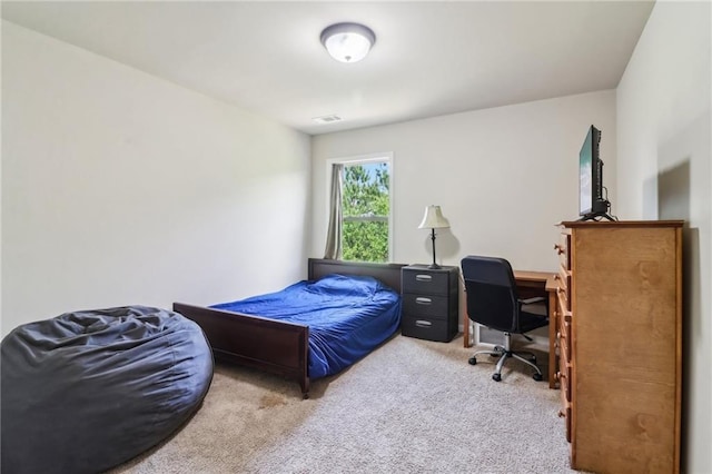 carpeted bedroom featuring visible vents