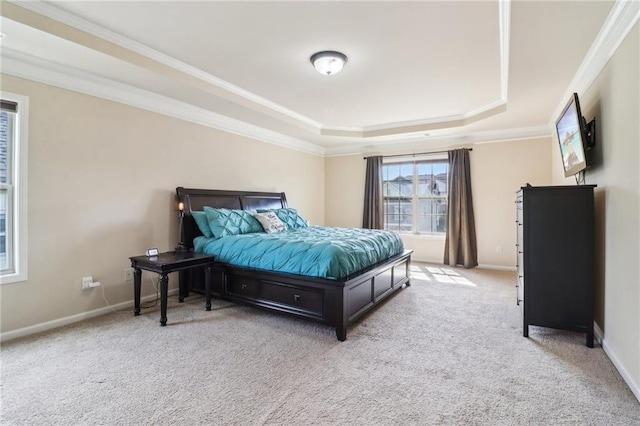 bedroom with light colored carpet, crown molding, and a tray ceiling