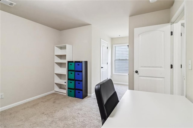 carpeted office space featuring visible vents and baseboards