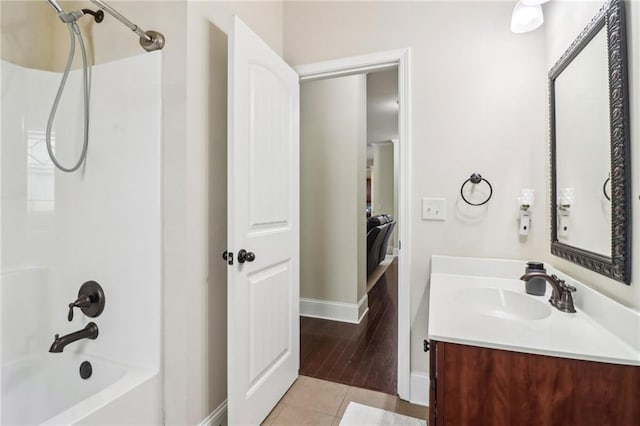 bathroom with baseboards, tile patterned floors, shower / bathing tub combination, and vanity