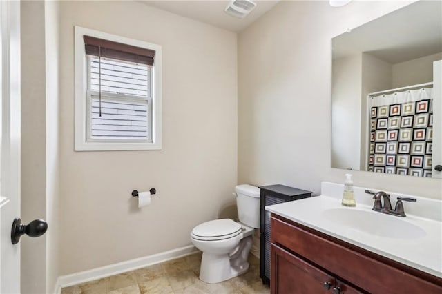 bathroom featuring vanity, baseboards, toilet, and visible vents