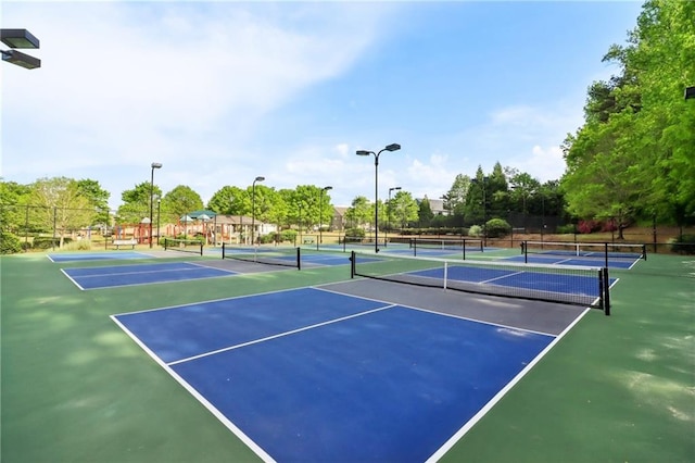 view of tennis court with fence and community basketball court