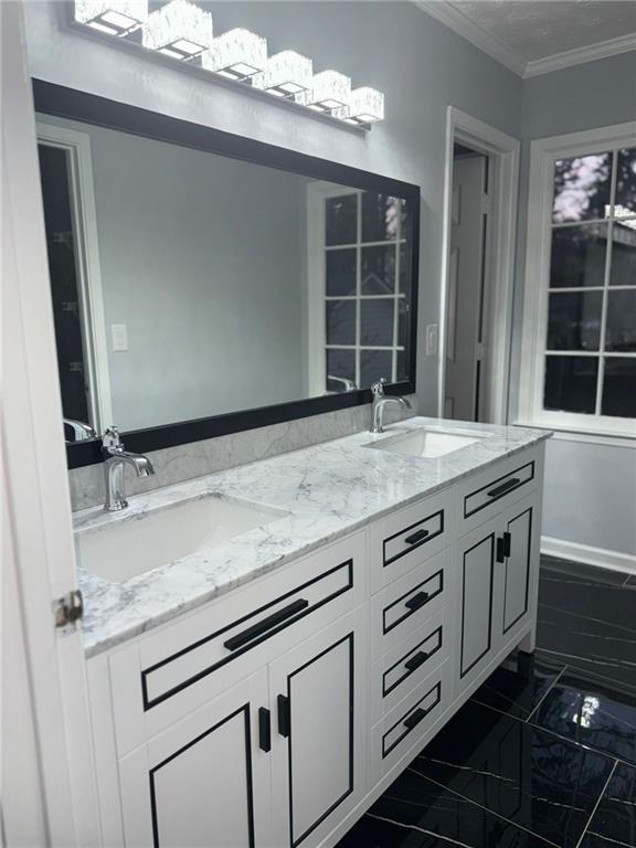 bathroom with vanity and ornamental molding