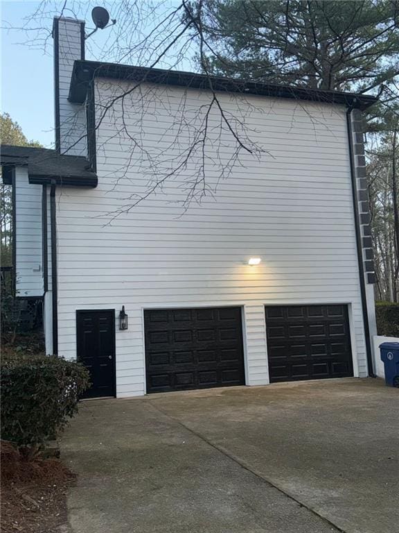 view of side of home with a garage