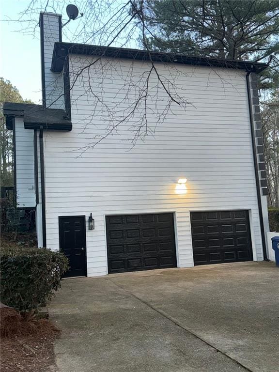 view of side of home with a garage