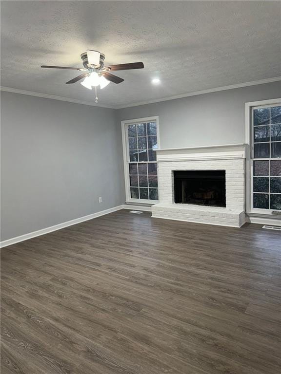 unfurnished living room with crown molding, a fireplace, and dark hardwood / wood-style flooring