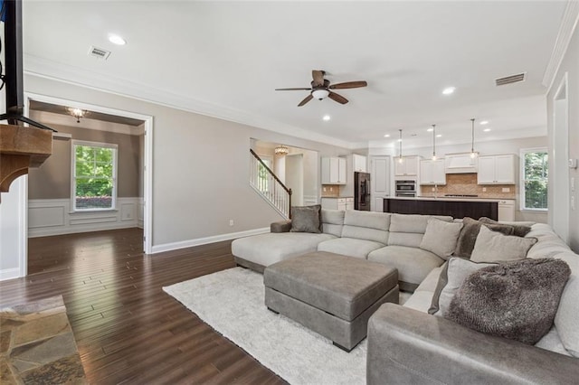 2040 Birchdale Dr, Milton, GA 30004 - living area featuring dark wood-style floors, ceiling fan, stairs, ornamental molding, and recessed lighting