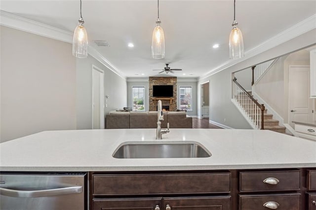 2040 Birchdale Dr, Milton, GA 30004 - kitchen with a sink, stainless steel dishwasher, dark brown cabinets, ceiling fan, and a stone fireplace