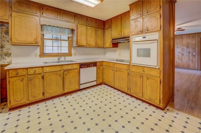 1830 Francis Rd SW, Conyers, GA 30094 - kitchen featuring white appliances, light flooring, light countertops, under cabinet range hood, and wooden walls
