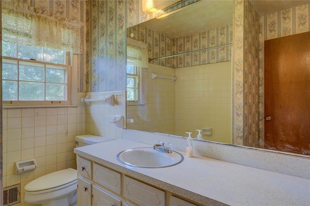 1830 Francis Rd SW, Conyers, GA 30094 - bathroom with wallpapered walls, healthy amount of natural light, vanity, and tile walls