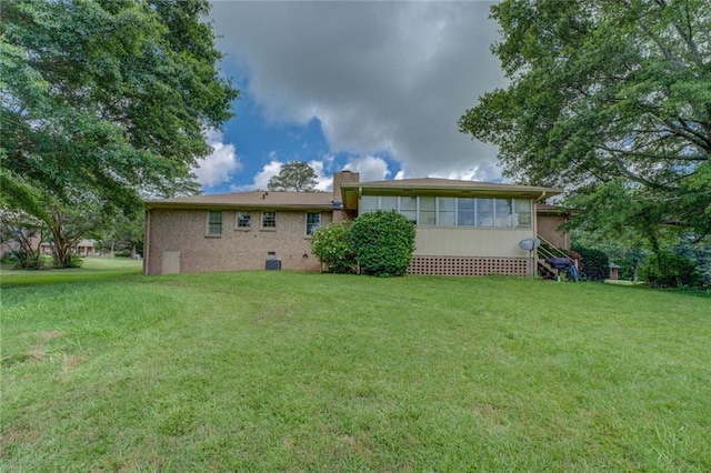 1830 Francis Rd SW, Conyers, GA 30094 - back of property featuring a lawn, a chimney, crawl space, and brick siding