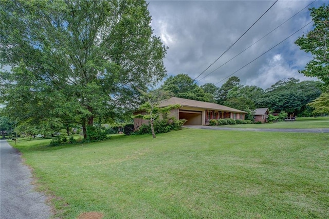 1830 Francis Rd SW, Conyers, GA 30094 - view of front facade with driveway, a front yard, and a garage