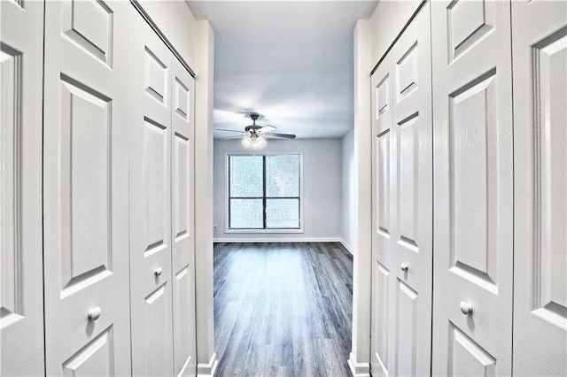 hall with baseboards and dark wood-style flooring