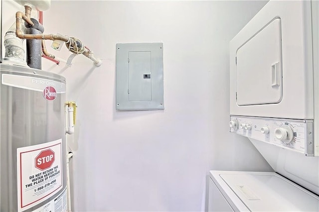 washroom with laundry area, electric panel, gas water heater, and stacked washer / dryer