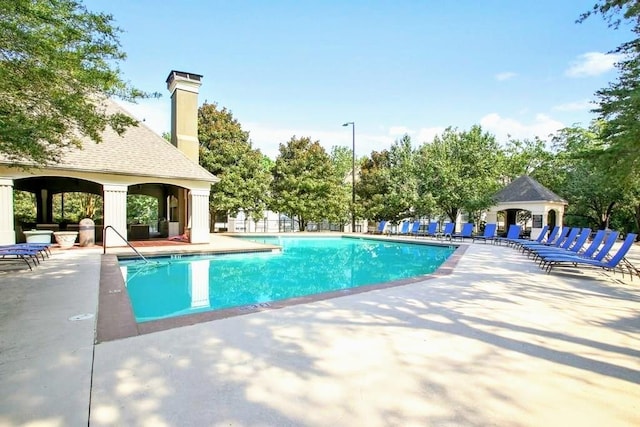 pool with a patio, a gazebo, and fence