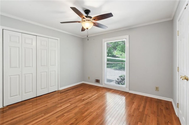 2055 Cactus Ln, Cumming, GA 30040 - unfurnished bedroom featuring hardwood / wood-style flooring, baseboards, a closet, crown molding, and a ceiling fan