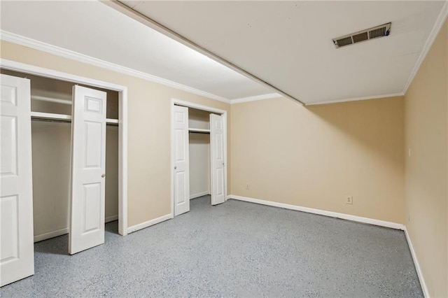 2055 Cactus Ln, Cumming, GA 30040 - unfurnished bedroom featuring multiple closets, baseboards, speckled floor, and crown molding