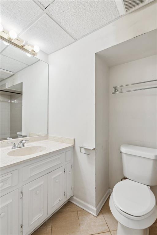 2055 Cactus Ln, Cumming, GA 30040 - bathroom with toilet, tile patterned flooring, vanity, a drop ceiling, and baseboards