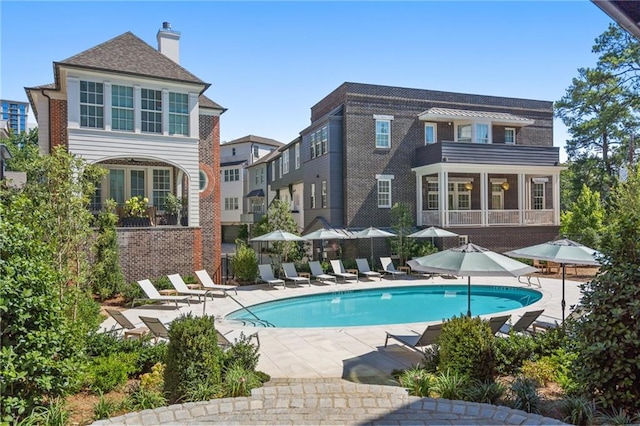 back of property featuring a sunroom and a patio area