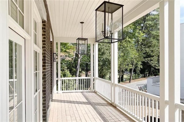 unfurnished sunroom featuring wooden ceiling and a wealth of natural light