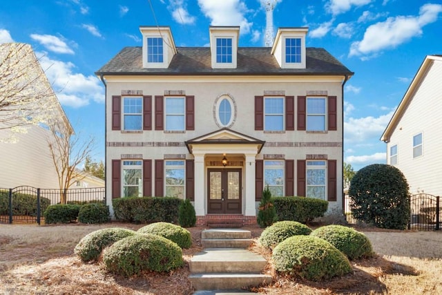 view of front of house featuring a gate, french doors, and fence