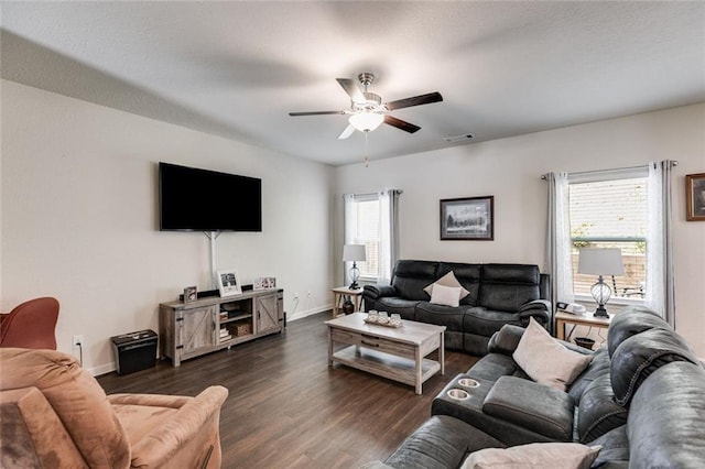 living room featuring dark hardwood / wood-style floors, a healthy amount of sunlight, and ceiling fan