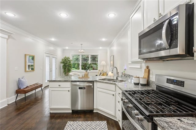 47 Oakridge Ave SE, Atlanta, GA 30317 - kitchen featuring stainless steel appliances, a peninsula, light stone counters, crown molding, and recessed lighting