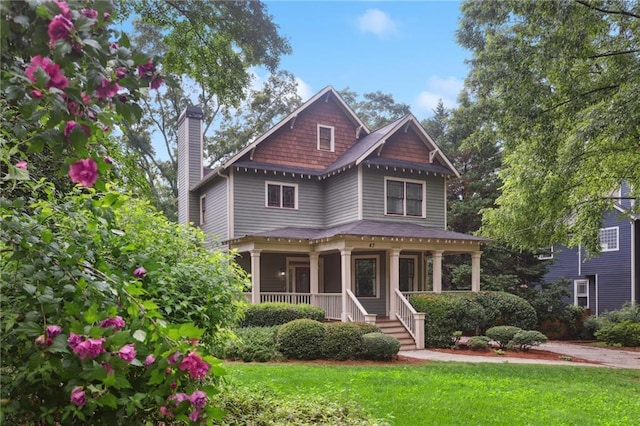 47 Oakridge Ave SE, Atlanta, GA 30317 - view of front facade featuring a chimney, covered porch, and a front lawn