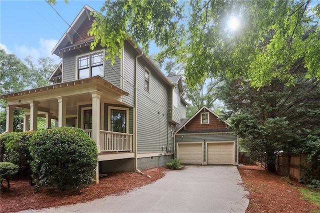 47 Oakridge Ave SE, Atlanta, GA 30317 - view of front of property featuring covered porch, a garage, an outdoor structure, and crawl space