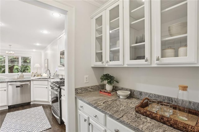 47 Oakridge Ave SE, Atlanta, GA 30317 - kitchen with stainless steel appliances, crown molding, glass insert cabinets, white cabinets, and light stone counters