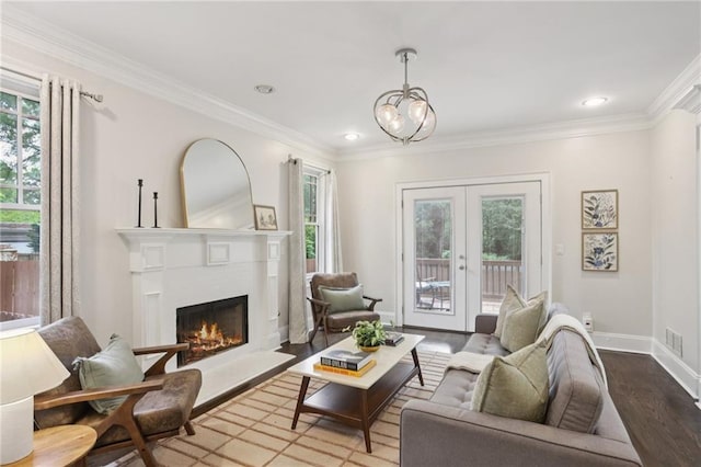 47 Oakridge Ave SE, Atlanta, GA 30317 - living area with wood finished floors, a warm lit fireplace, crown molding, a chandelier, and french doors