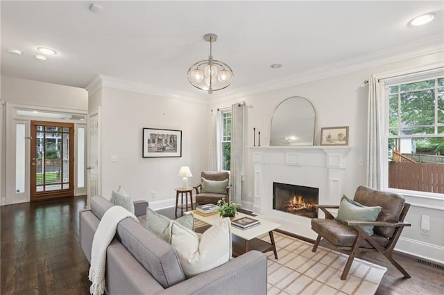 47 Oakridge Ave SE, Atlanta, GA 30317 - living area featuring plenty of natural light, a lit fireplace, a chandelier, ornamental molding, and wood finished floors