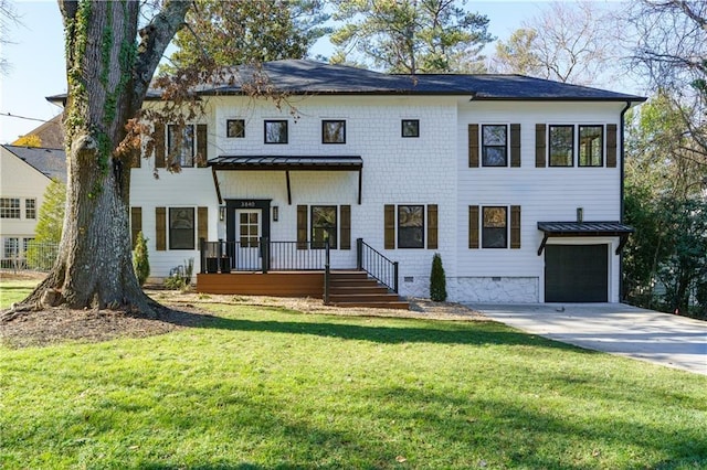 view of front of property with a garage, a front yard, and covered porch